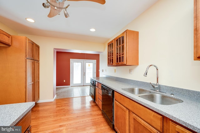 kitchen featuring black dishwasher, ceiling fan, light hardwood / wood-style floors, french doors, and sink