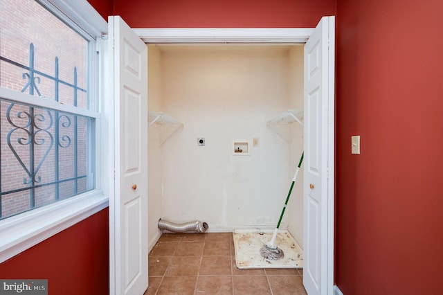 washroom featuring hookup for an electric dryer, washer hookup, and light tile patterned floors