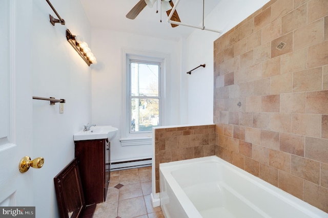 bathroom featuring vanity, ceiling fan, baseboard heating, a bathtub, and tile patterned flooring