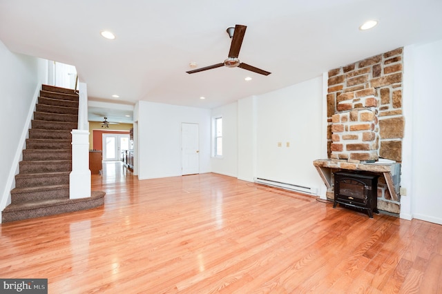 unfurnished living room with a baseboard radiator, ceiling fan, and light hardwood / wood-style flooring