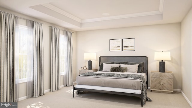 carpeted bedroom with ornamental molding and a tray ceiling