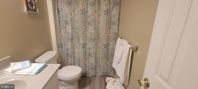 bathroom featuring hardwood / wood-style floors, vanity, toilet, and a shower with shower curtain