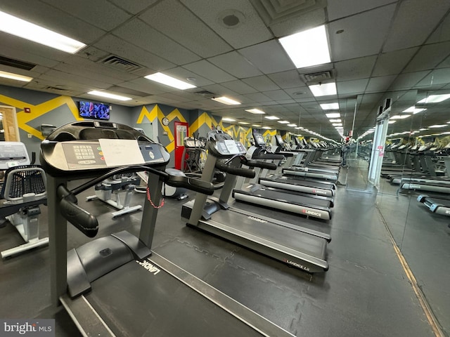exercise room with a paneled ceiling