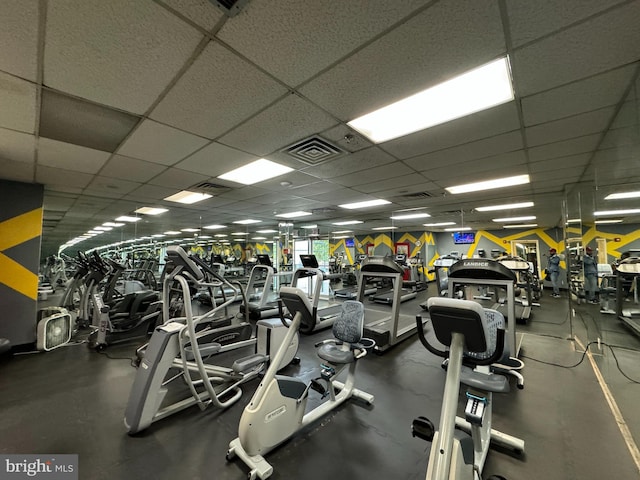 gym with a paneled ceiling
