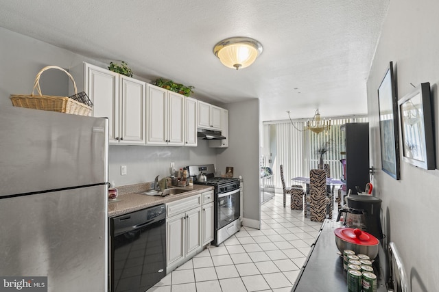 kitchen featuring white cabinetry, a textured ceiling, light tile patterned flooring, sink, and stainless steel appliances