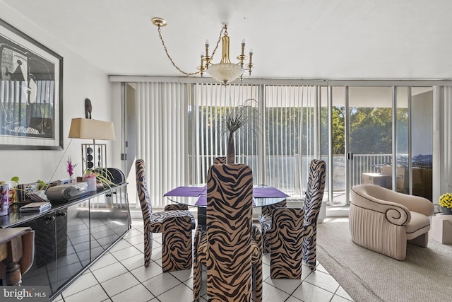 dining area with expansive windows, a notable chandelier, and light tile patterned floors