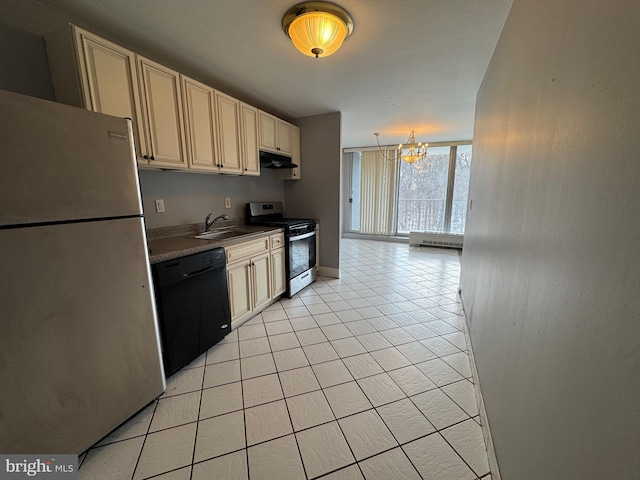 kitchen with appliances with stainless steel finishes, under cabinet range hood, cream cabinetry, a sink, and a chandelier