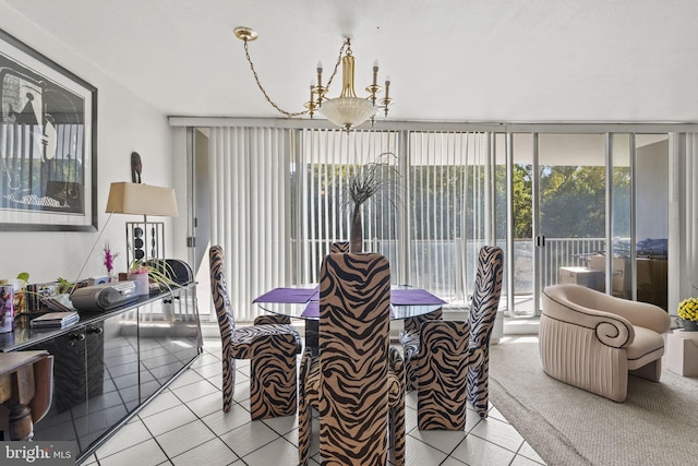 sunroom / solarium featuring a chandelier