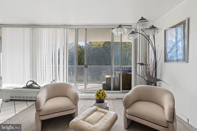 living area with plenty of natural light and tile patterned flooring