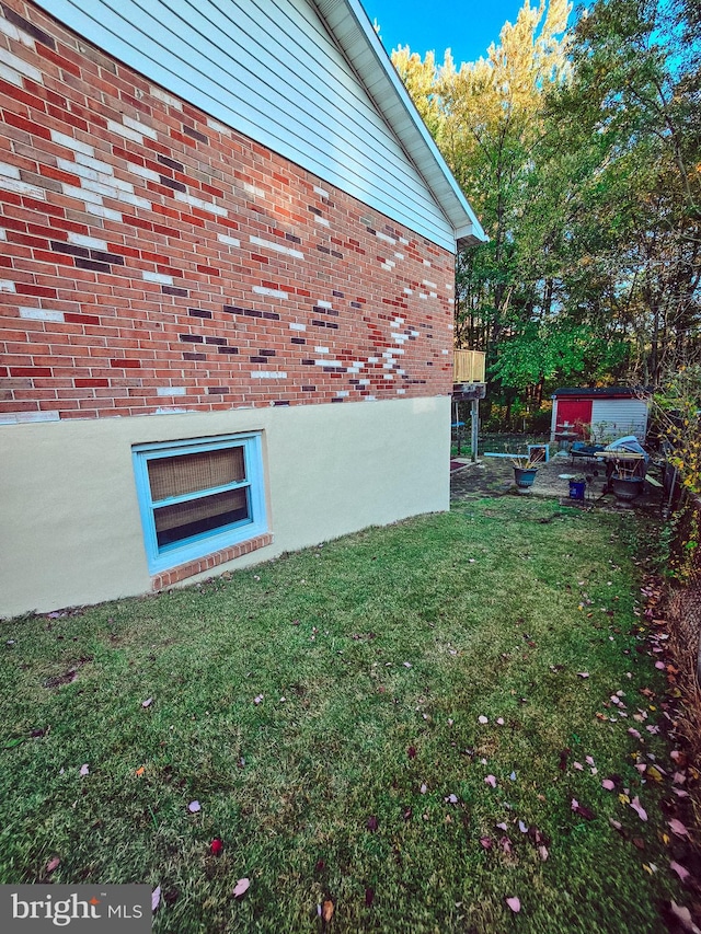 view of side of home featuring a yard