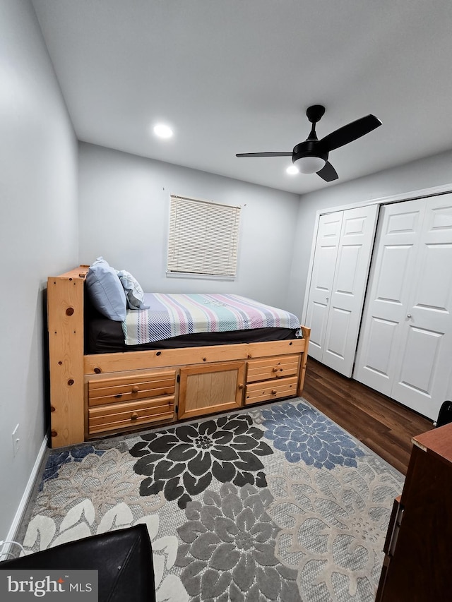 bedroom with ceiling fan, dark hardwood / wood-style floors, and a closet