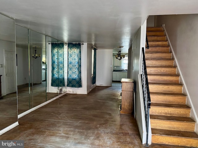 interior space with a notable chandelier and dark hardwood / wood-style flooring