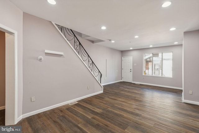 unfurnished living room with dark hardwood / wood-style flooring