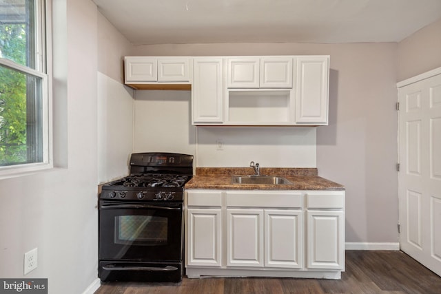 kitchen with sink, white cabinetry, black gas range oven, and dark hardwood / wood-style floors