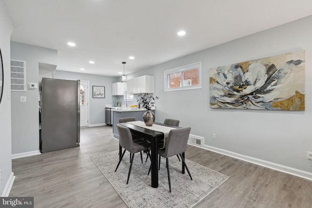 dining space with light wood-type flooring