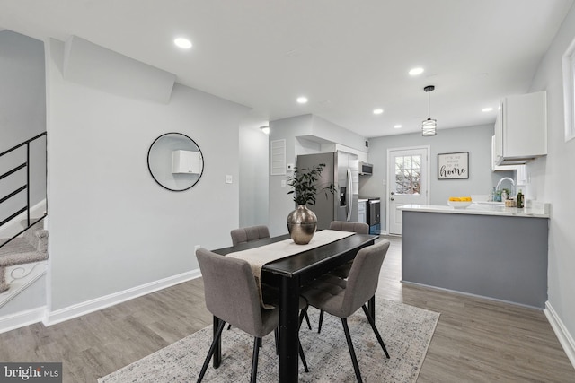 dining space with light hardwood / wood-style flooring