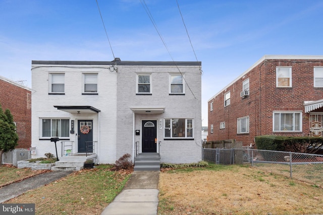 view of property featuring a front lawn