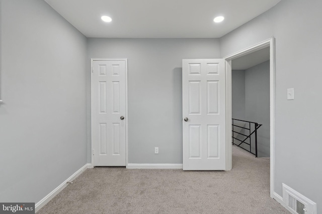 unfurnished bedroom featuring light colored carpet