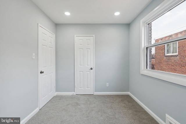 unfurnished bedroom featuring light colored carpet