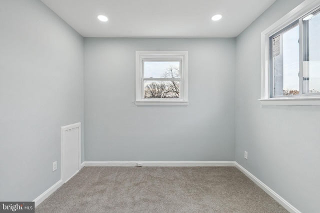 unfurnished room with light colored carpet