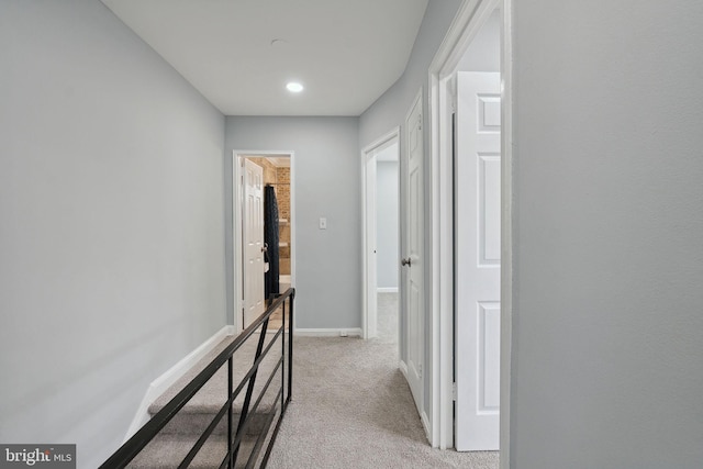 corridor featuring light colored carpet