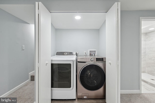 laundry room with light carpet and washing machine and clothes dryer