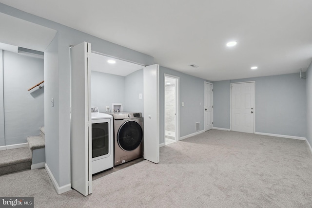 laundry area with light carpet and washing machine and dryer