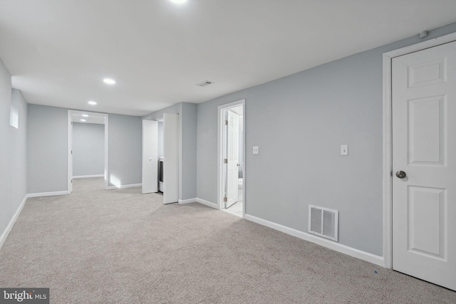 basement featuring light colored carpet