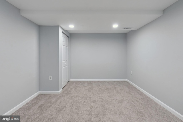 spare room featuring light carpet