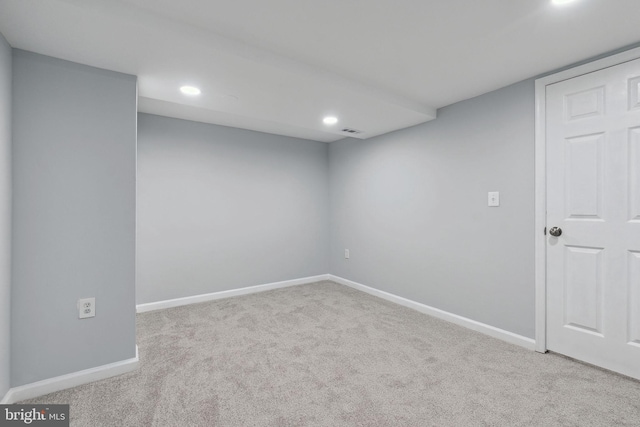 basement featuring light carpet