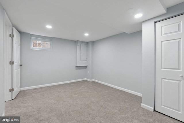 basement featuring light carpet