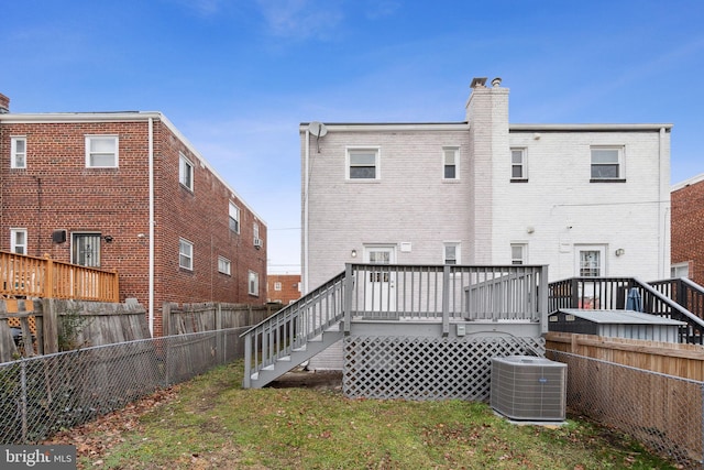 back of property featuring central AC and a wooden deck