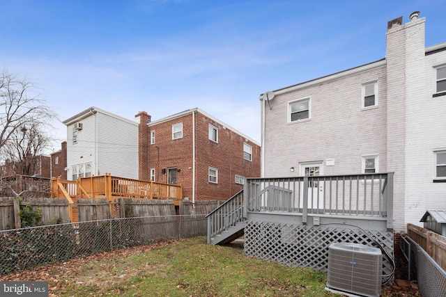 rear view of house with central air condition unit and a deck