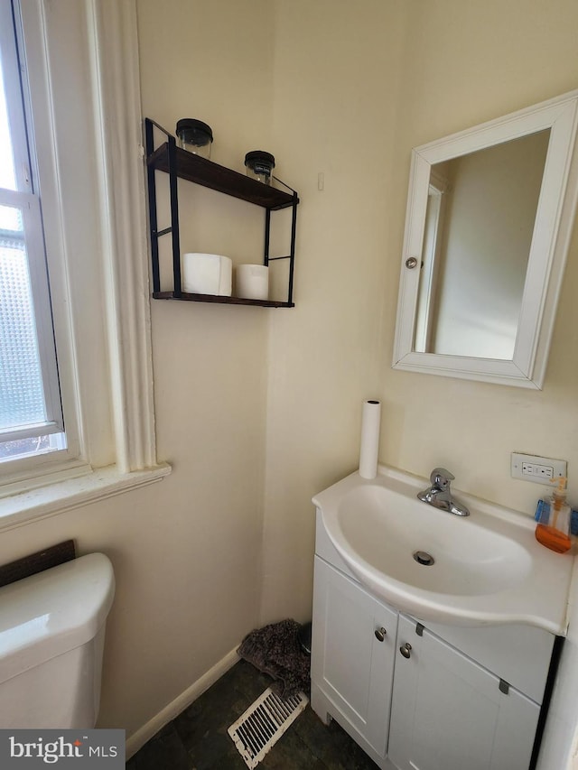 bathroom with vanity, toilet, and tile patterned flooring