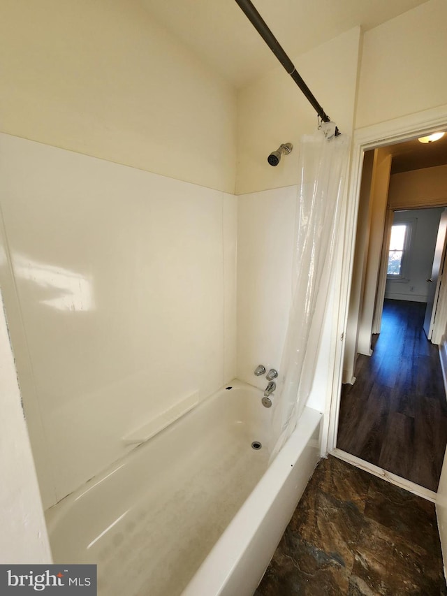 bathroom featuring shower / tub combo with curtain and hardwood / wood-style flooring