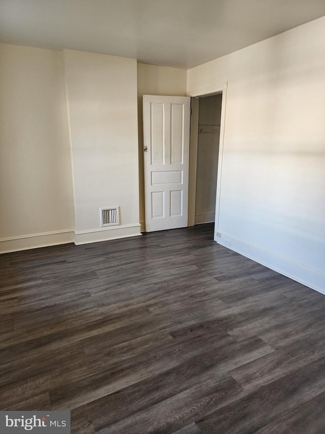 empty room with dark hardwood / wood-style floors