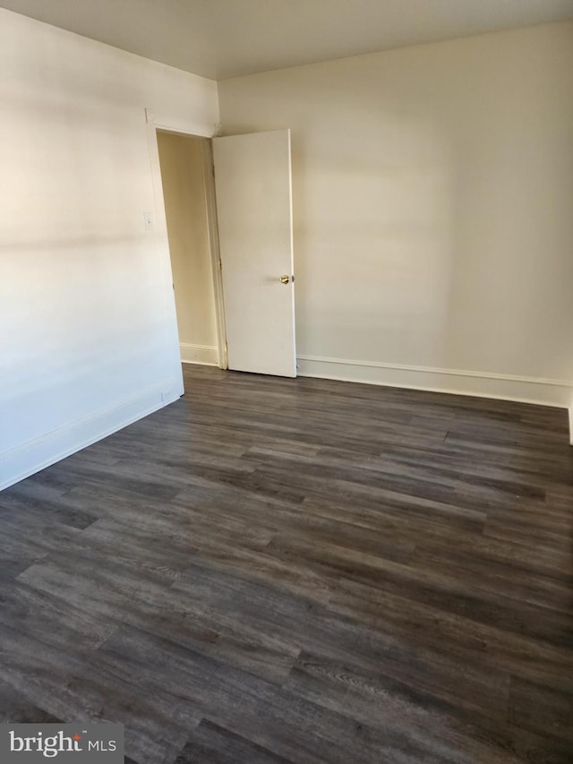 empty room with dark hardwood / wood-style floors