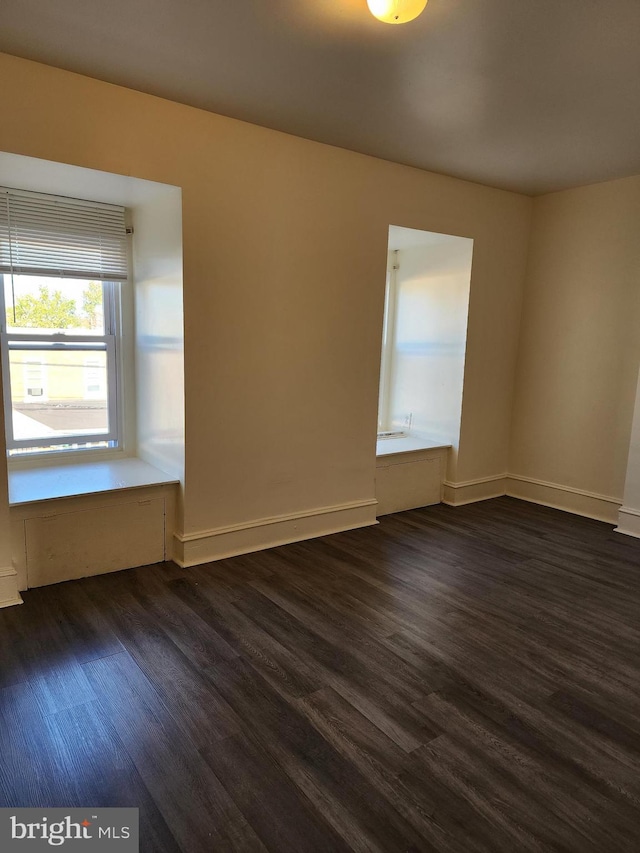 empty room with dark wood-type flooring