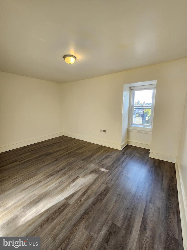 unfurnished room with dark hardwood / wood-style floors