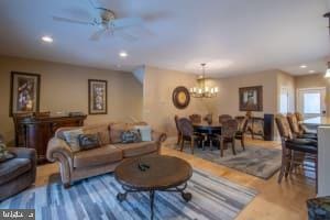 living room featuring wood-type flooring and ceiling fan with notable chandelier