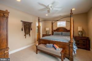 carpeted bedroom with ceiling fan