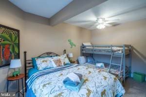 bedroom with beam ceiling and ceiling fan