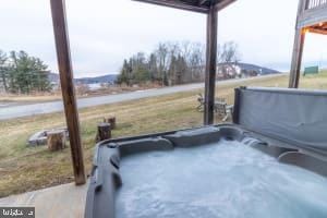 view of patio / terrace with a hot tub