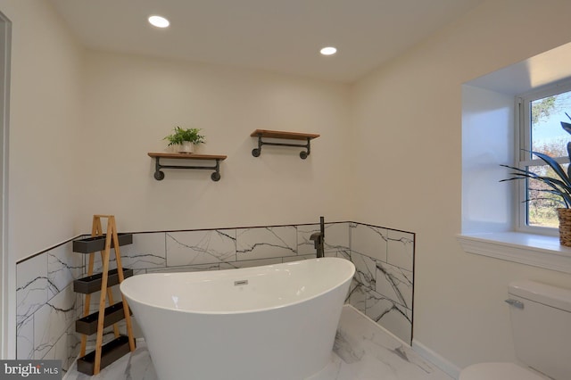 bathroom with toilet and a bathtub