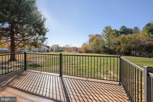 wooden terrace featuring a yard