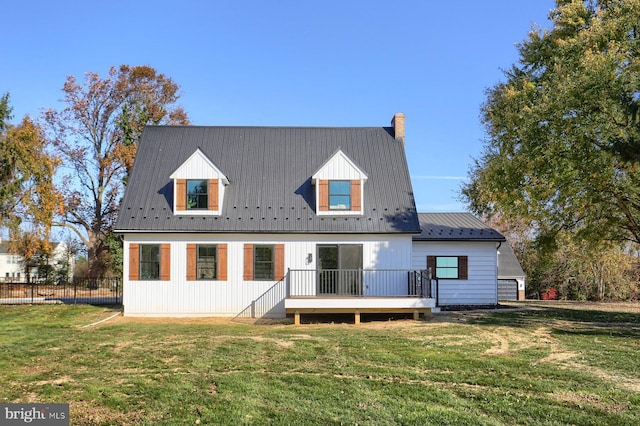 back of property featuring a yard and a wooden deck