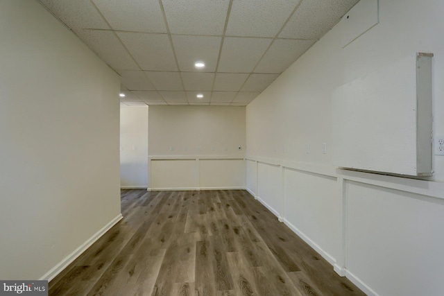 interior space featuring a paneled ceiling and wood-type flooring