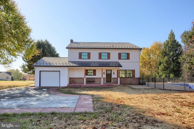 view of front of home featuring a garage and a porch