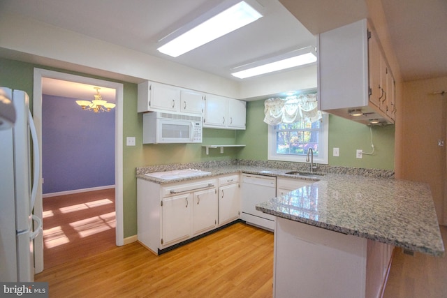 kitchen featuring white cabinetry, kitchen peninsula, light hardwood / wood-style flooring, and white appliances