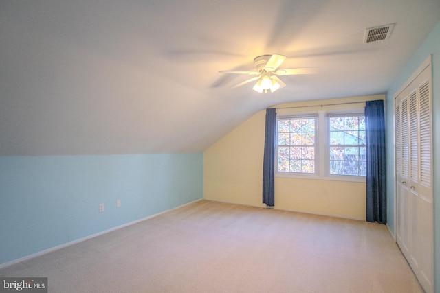 bonus room with light colored carpet, ceiling fan, and vaulted ceiling